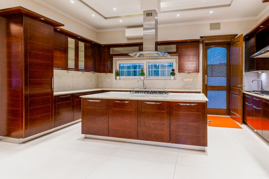 Painted cabinetry and a countertop in a finished room