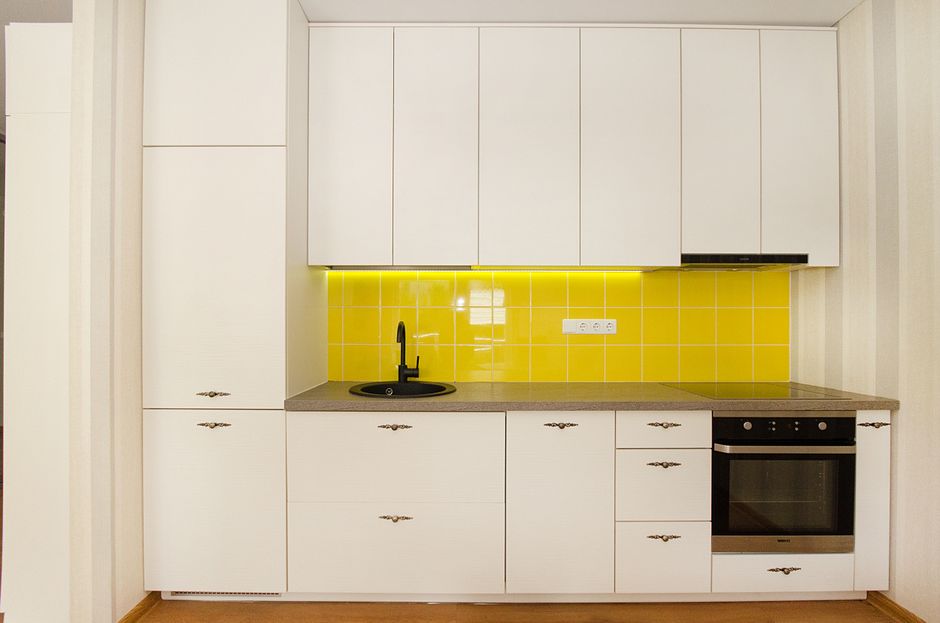 Painted cabinetry and a countertop in a finished room